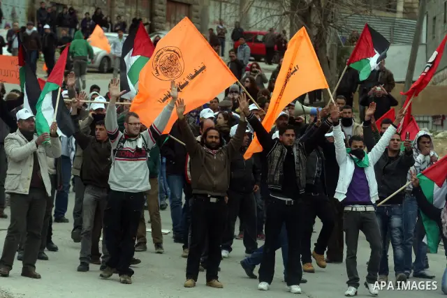 Palestinian demonstrators, joined by Israeli and foreign peace activists, shout slogans during a demonstration demanding the reopening of a key street in the West Bank city of Hebron on February 24, 2012. Hundreds of Pal...