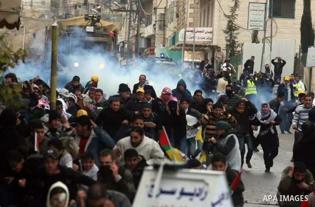 Palestinians protesters clash with Israeli soldiers during a demonstration commemorating 18 years to the Hebron massacre and calling to open Shuhada street in the West Bank city of Hebron, Friday, Feb. 24, 2012. In 1994,...