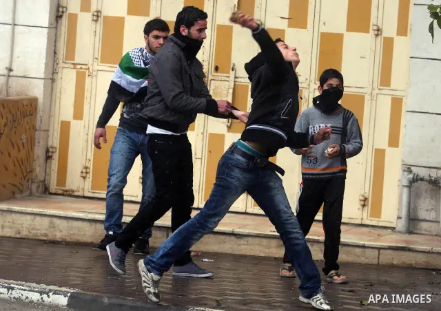 Palestinians protesters clash with Israeli soldiers during a demonstration commemorating 18 years to the Hebron massacre and calling to open Shuhada street in the West Bank city of Hebron, Friday, Feb. 24, 2012. In 1994,...
