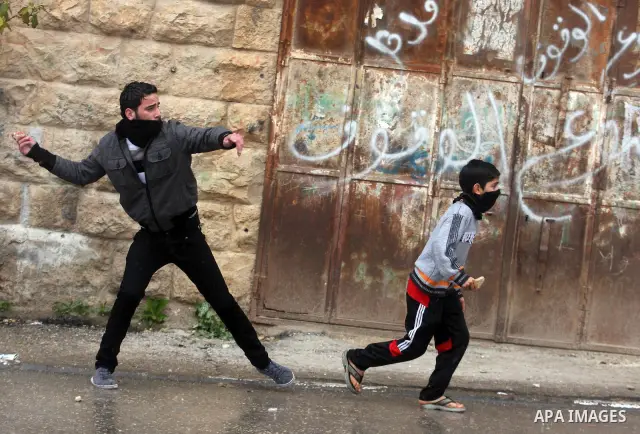 Palestinians protesters clash with Israeli soldiers during a demonstration commemorating 18 years to the Hebron massacre and calling to open Shuhada street in the West Bank city of Hebron, Friday, Feb. 24, 2012. In 1994,...