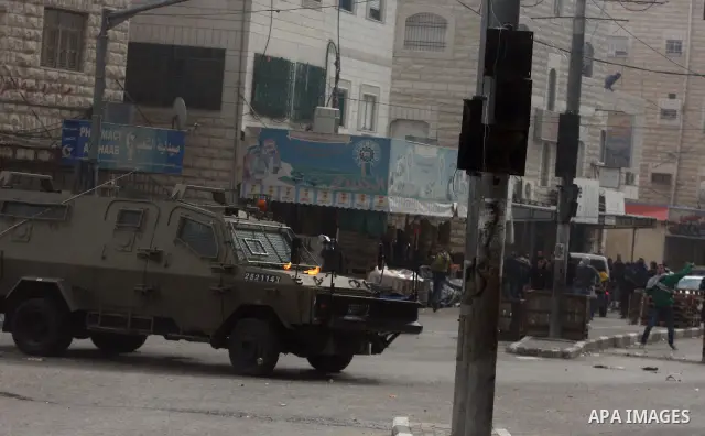 Palestinians protesters clash with Israeli soldiers during a demonstration commemorating 18 years to the Hebron massacre and calling to open Shuhada street in the West Bank city of Hebron, Friday, Feb. 24, 2012. In 1994,...