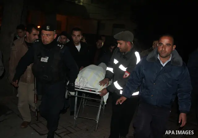 Palestinians relatives mourn over the body of Talat Ramya "25", killed by Israeli military, during clashes following a weekly demonstration at the West bank refugee camp of Qalandia, near Ramallah, on Feb. 24. 2012. Phot...