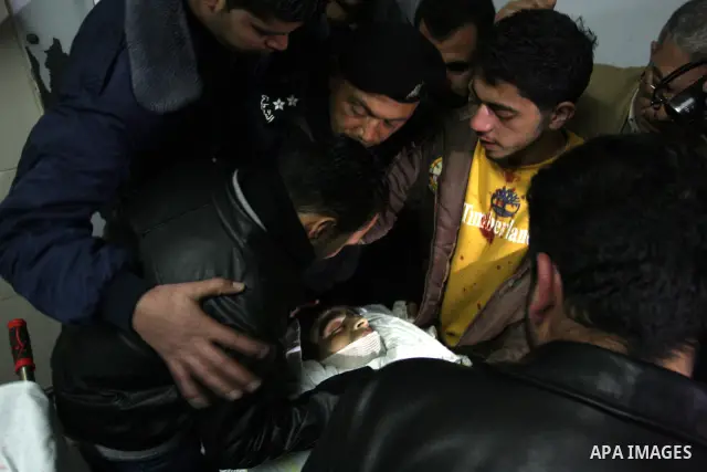 Palestinians relatives mourn over the body of Talat Ramya "25", killed by Israeli military, during clashes following a weekly demonstration at the West bank refugee camp of Qalandia, near Ramallah, on Feb. 24. 2012. Phot...