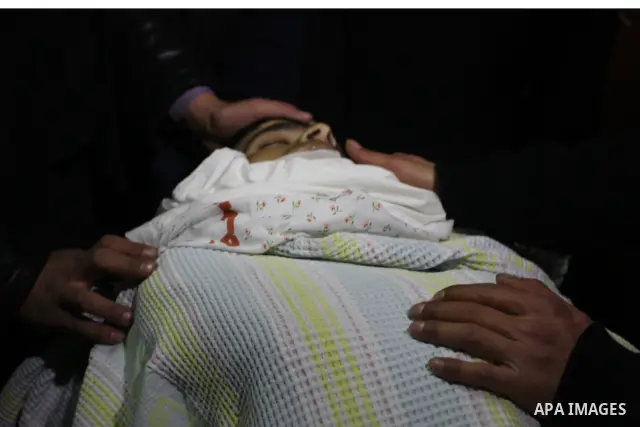 Palestinians relatives mourn over the body of Talat Ramya "25", killed by Israeli military, during clashes following a weekly demonstration at the West bank refugee camp of Qalandia, near Ramallah, on Feb. 24. 2012. Phot...