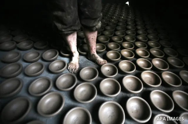 Palestinian Sabri Atallah, stores pots built with natural clay at his grandfather's shop 'Atallah Pottery', in Gaza Strip on 23 February 2012. Atallah pottery shop is one of the biggest pottery shops in Gaza strip. Child...