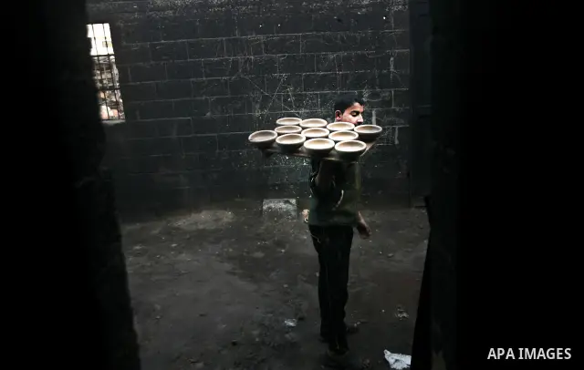 Palestinian Sabri Atallah, stores pots built with natural clay at his grandfather's shop 'Atallah Pottery', in Gaza Strip on 24 February 2012. Atallah pottery shop is one of the biggest pottery shops in Gaza strip. Child...