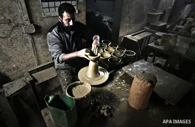 Palestinian Ayman Atallah, stores pots built with natural clay at his grandfather's shop 'Atallah Pottery', in Gaza Strip on 23 February 2012. Atallah pottery shop is one of the biggest pottery shops in Gaza strip. Child...