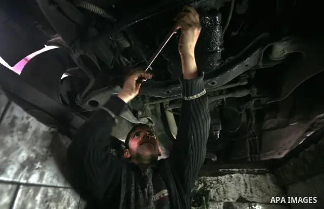 Palestinian children work repairing a car tyre in the town of Beit Lahyia in northern Gaza on 23 February 2012. Reports state that child labor is widespread in the Gaza Strip because of the high rate of poverty and unemp...