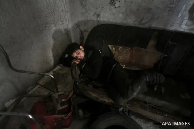 Palestinian 11 year old Anis, sleeps during his rest period after his working repairing a customers car in the town of Beit Lahyia in northern Gaza on 23 February 2012. Reports state that child labor is widespread in the...