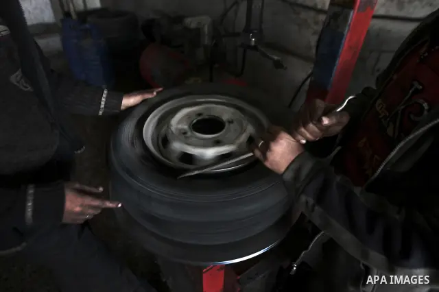 Palestinian children work repairing a car tyre in the town of Beit Lahyia in northern Gaza on 23 February 2012. Reports state that child labor is widespread in the Gaza Strip because of the high rate of poverty and unemp...