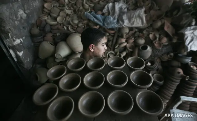 Palestinian Sabri Atallah, stores pots built with natural clay at his grandfather's shop 'Atallah Pottery', in Gaza Strip on 24 February 2012. Atallah pottery shop is one of the biggest pottery shops in Gaza strip. Child...