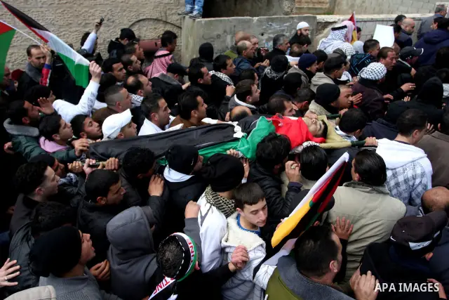 Palestinians carry the body of 23-year-old Talat Ramia during his funeral in the West Bank town of Al-Ram, near Jerusalem February 25, 2012. Ramia, a Palestinian protester who participated in clashes against Israeli sold...