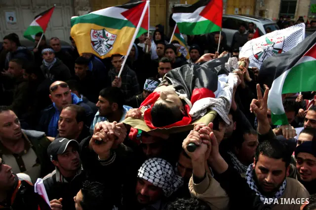 Palestinians carry the body of 23-year-old Talat Ramia during his funeral in the West Bank town of Al-Ram, near Jerusalem February 25, 2012. Ramia, a Palestinian protester who participated in clashes against Israeli sold...