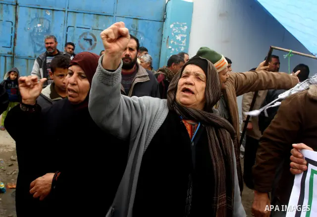 Palestinians take part in a protest in front of the UNRWA headquarters, against reducing the services provided to Palestine refugees in Gaza city, on Feb. 26, 2012. Photo by Ashraf Amra