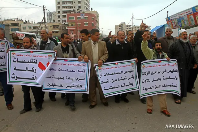 Palestinians take part in a protest in front of the UNRWA headquarters, against reducing the services provided to Palestine refugees in Gaza city, on Feb. 26, 2012. Photo by Ashraf Amra