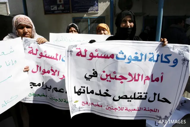 Palestinians take part during a protest against the suspension of aid provided to them from the Agency Relief and Works Agency (UNRWA) during a protest in front of one of the centers of the distribution of aid to UNRWA i...