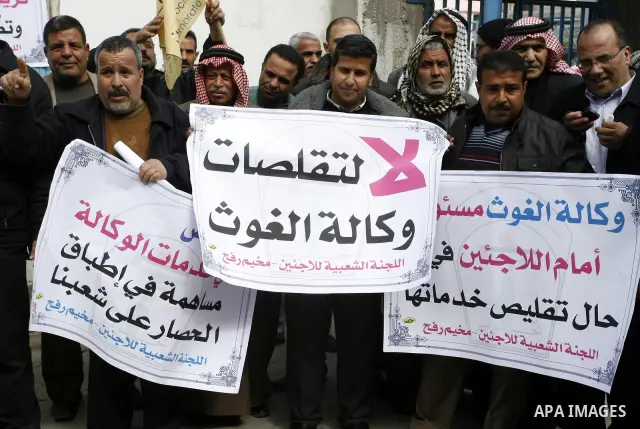 Palestinians take part during a protest against the suspension of aid provided to them from the Agency Relief and Works Agency (UNRWA) during a protest in front of one of the centers of the distribution of aid to UNRWA i...
