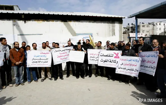Palestinians take part during a protest against the suspension of aid provided to them from the Agency Relief and Works Agency (UNRWA) during a protest in front of one of the centers of the distribution of aid to UNRWA i...