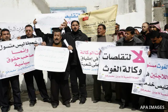 Palestinians take part during a protest against the suspension of aid provided to them from the Agency Relief and Works Agency (UNRWA) during a protest in front of one of the centers of the distribution of aid to UNRWA i...