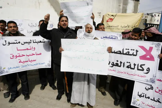 Palestinians take part during a protest against the suspension of aid provided to them from the Agency Relief and Works Agency (UNRWA) during a protest in front of one of the centers of the distribution of aid to UNRWA i...