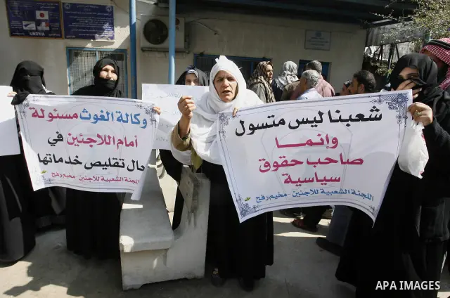 Palestinians take part during a protest against the suspension of aid provided to them from the Agency Relief and Works Agency (UNRWA) during a protest in front of one of the centers of the distribution of aid to UNRWA i...