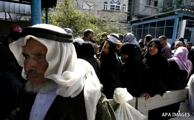 Palestinians receive their monthly food aid at a UN distribution center in the Rafah refugee camp, southern Gaza Strip on February 26, 2012. Photo by Abed Rahim Khatib