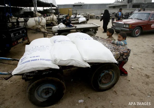 Palestinians receive their monthly food aid at a UN distribution center in the Rafah refugee camp, southern Gaza Strip on February 26, 2012. Photo by Abed Rahim Khatib