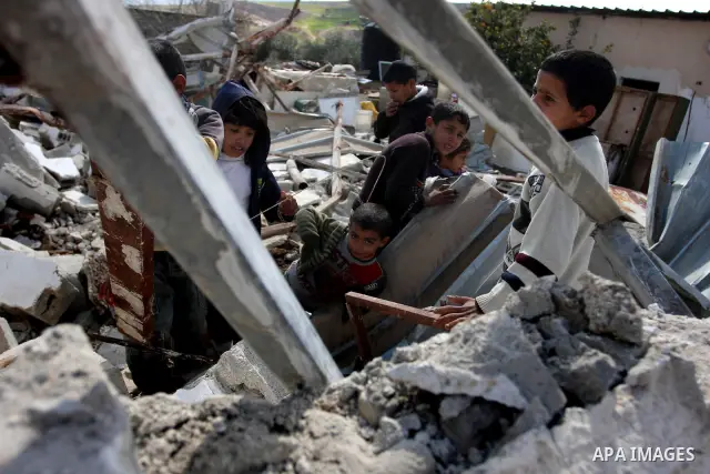 Palestinian Children inspects their hous which was demolished by Israeli army that was built without a construction permit, in bedouin area, village of Jaba, north of Jerusalem on Feb. 27, 2012. Photo by Issam Rimawi