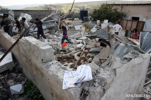 Palestinian Children inspects their hous which was demolished by Israeli army that was built without a construction permit, in bedouin area, village of Jaba, north of Jerusalem on Feb. 27, 2012. Photo by Issam Rimawi
