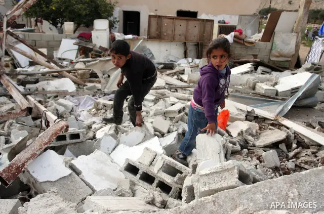 Palestinian Children inspects their hous which was demolished by Israeli army that was built without a construction permit, in bedouin area, village of Jaba, north of Jerusalem on Feb. 27, 2012. Photo by Issam Rimawi