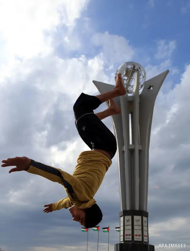 A Palestinian boy enjoys practicing jump on the beach in Gaza City, on Feb. 28, 2012. Photo by Wisam Nassar