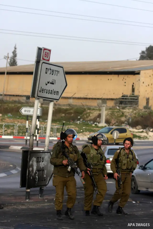 An Israeli soldier fires tear gas during clashes with stone-throwing Palestinians in the West Bank district of al-Ram, bordering Israel and annexed East Jerusalem, on February 28, 2012. Photo by Issam Rimawi