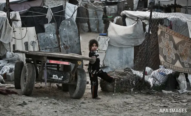 A Palestinian girl stand beside a cart in between makeshift tents in one of the poorest regions in the Al-Zaiton neighbourhood, in the Gaza strip, 28 February 2012. The United Nations Relief and Works Agency for Palestin...