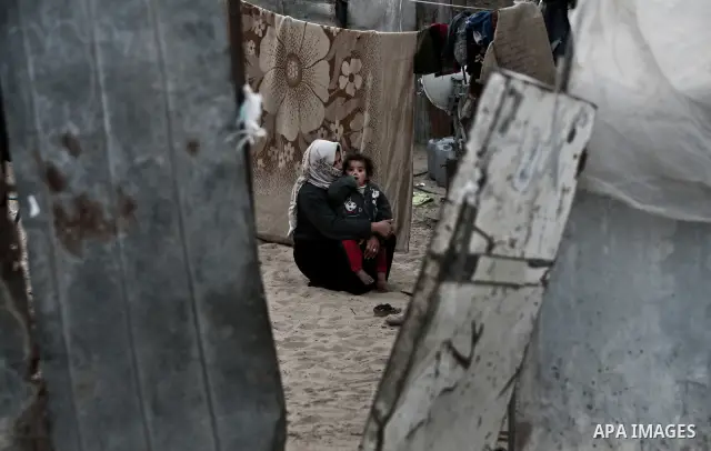 A Palestinian mother Embraces her child at their house inbetween makeshift tents in one of the most poor regions in Al-Nusirat neighborhood, central Gaza Strip on 28 February 2012. The United Nations Relief and Works Age...