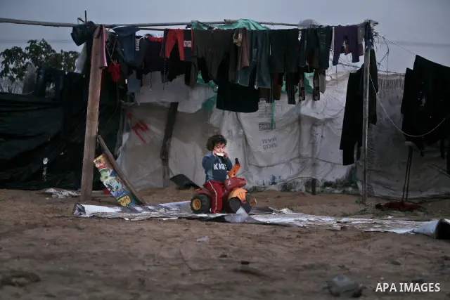 A Palestinian boy eating bread inside his family house inbetween makeshift tents in one of the most poor regions in Al-Nusirat neighborhood, central Gaza Strip on 28 February 2012. The United Nations Relief and Works Age...