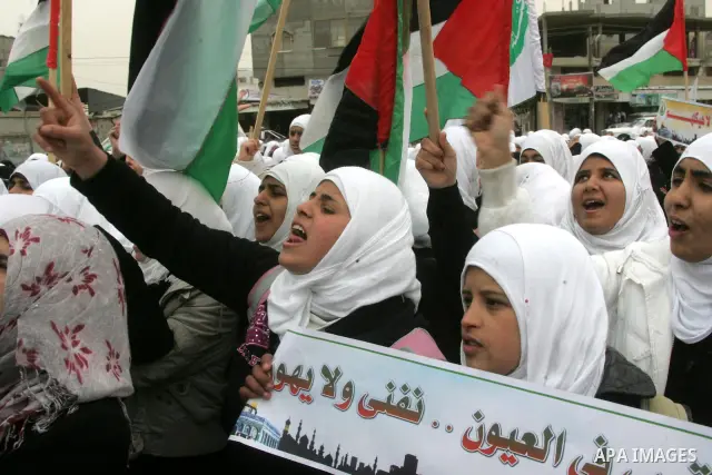 Palestinians female students shout slogans as she and others take part in a protest organized by the Islamic Hamas movement in the Rafah, southern Gaza Strip, on February 29, 2012, to show solidarity with Palestinians pr...