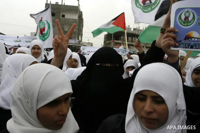 Palestinians female students shout slogans as she and others take part in a protest organized by the Islamic Hamas movement in the Rafah, southern Gaza Strip, on February 29, 2012, to show solidarity with Palestinians pr...