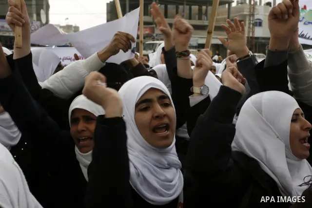 Palestinians female students shout slogans as she and others take part in a protest organized by the Islamic Hamas movement in the Rafah, southern Gaza Strip, on February 29, 2012, to show solidarity with Palestinians pr...