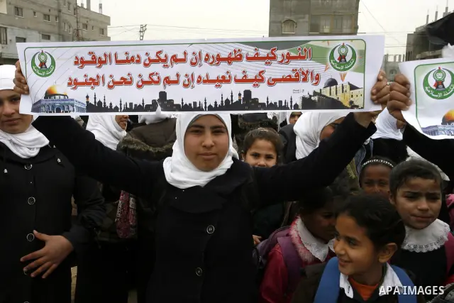 Palestinians female students shout slogans as she and others take part in a protest organized by the Islamic Hamas movement in the Rafah, southern Gaza Strip, on February 29, 2012, to show solidarity with Palestinians pr...