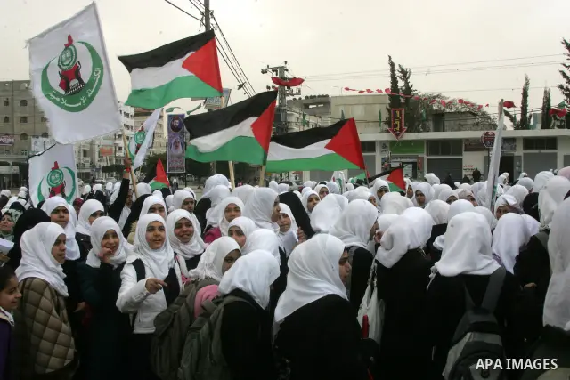Palestinians female students shout slogans as she and others take part in a protest organized by the Islamic Hamas movement in the Rafah, southern Gaza Strip, on February 29, 2012, to show solidarity with Palestinians pr...