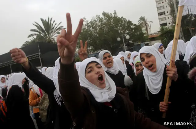 Palestinians female students shout slogans as she and others take part in a protest organized by the Islamic Hamas movement in Gaza city, on February 29, 2012, to show solidarity with Palestinians protesting last week at...