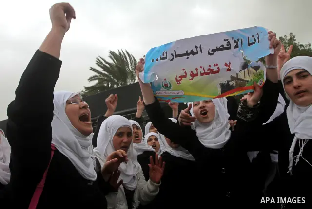 Palestinians female students shout slogans as she and others take part in a protest organized by the Islamic Hamas movement in Gaza city, on February 29, 2012, to show solidarity with Palestinians protesting last week at...
