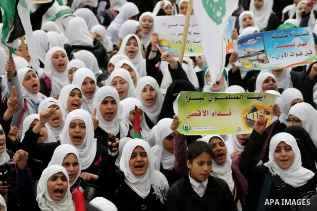 Palestinians female students shout slogans as she and others take part in a protest organized by the Islamic Hamas movement in Gaza city, on February 29, 2012, to show solidarity with Palestinians protesting last week at...