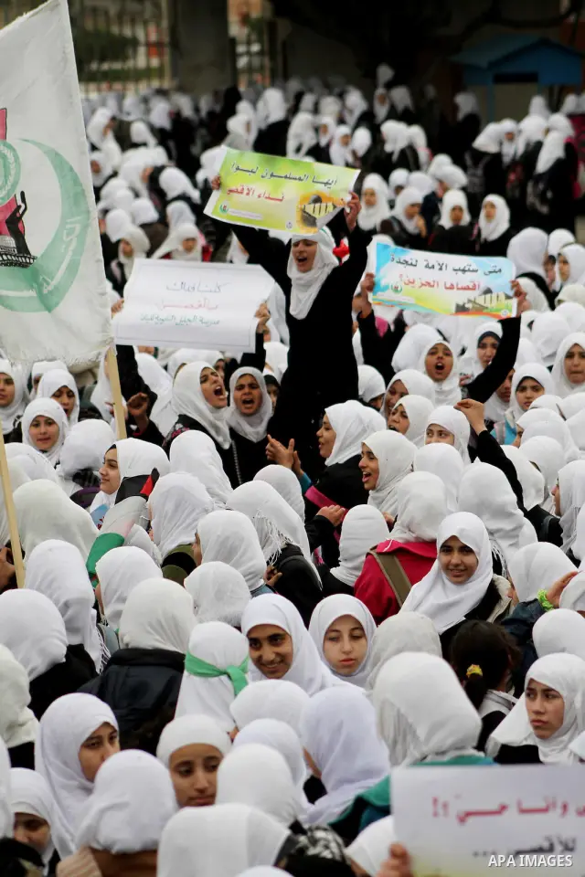 Palestinians female students shout slogans as she and others take part in a protest organized by the Islamic Hamas movement in Gaza city, on February 29, 2012, to show solidarity with Palestinians protesting last week at...