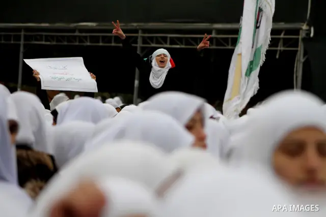 Palestinians female students shout slogans as she and others take part in a protest organized by the Islamic Hamas movement in Gaza city, on February 29, 2012, to show solidarity with Palestinians protesting last week at...