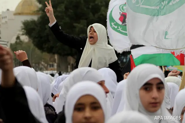 Palestinians female students shout slogans as she and others take part in a protest organized by the Islamic Hamas movement in Gaza city, on February 29, 2012, to show solidarity with Palestinians protesting last week at...