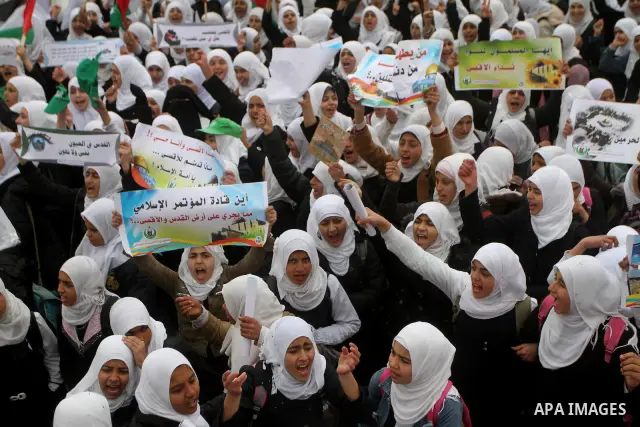 Palestinians female students shout slogans as she and others take part in a protest organized by the Islamic Hamas movement in Gaza city, on February 29, 2012, to show solidarity with Palestinians protesting last week at...