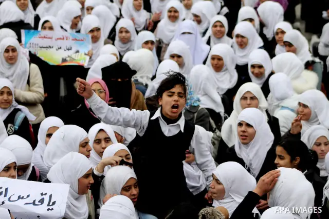 Palestinians female students shout slogans as she and others take part in a protest organized by the Islamic Hamas movement in Gaza city, on February 29, 2012, to show solidarity with Palestinians protesting last week at...