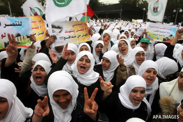 Palestinians female students shout slogans as she and others take part in a protest organized by the Islamic Hamas movement in Gaza city, on February 29, 2012, to show solidarity with Palestinians protesting last week at...