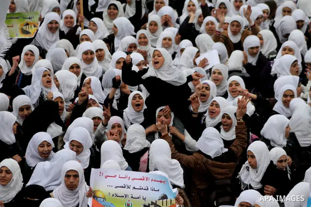 Palestinians female students shout slogans as she and others take part in a protest organized by the Islamic Hamas movement in Gaza city, on February 29, 2012, to show solidarity with Palestinians protesting last week at...